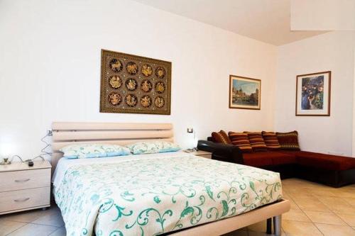 a bedroom with a bed and a couch at Le Dune in San Teodoro