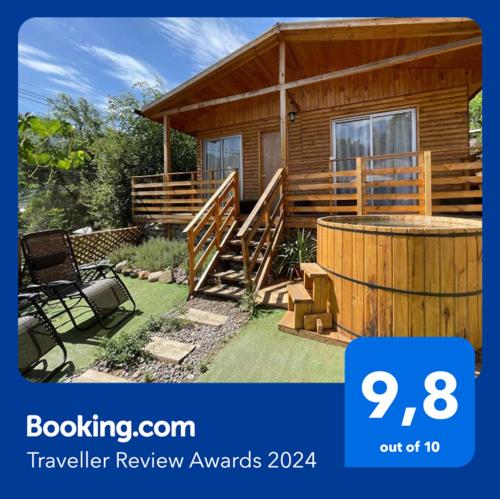a log cabin with a deck and a hot tub at Cabañas del Maipo - Cabaña Maipo in San José de Maipo