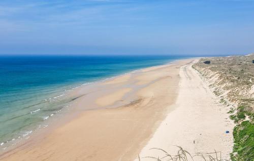 an empty beach with the ocean in the background at Stunning Home In L'étang-Bertrand in L'Etang-Bertrand