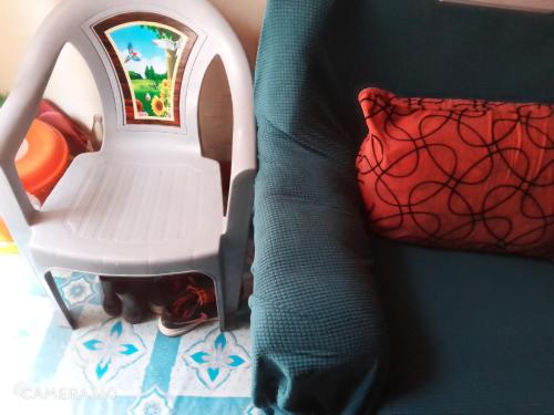 a toy chair with a cat sitting in it at Cosy budget Single room in Nairobi