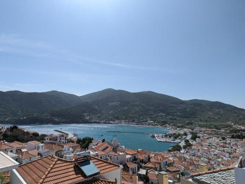 a view of a town with a river and houses at The Botanist Guesthouse in Skopelos Town