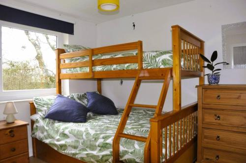 a bedroom with two bunk beds and a window at Ocean Breeze, Gower Holiday Village. Allows Dogs in Swansea