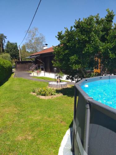 a view of a yard with a swimming pool at Ferienhaus Kumpitsch in Sankt Johann im Saggautal