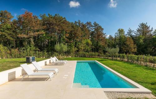a swimming pool with two lounge chairs and a swimming pool at Villa-Vesta in Višnjan