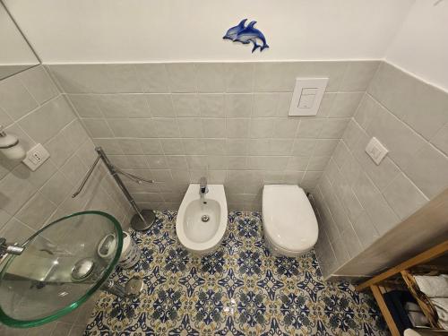 a bathroom with a sink and a toilet and a shower at il faro di serapide in Naples