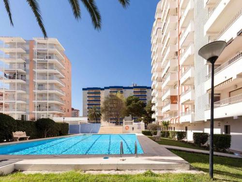 an empty swimming pool in front of some buildings at Apartamento gandiaziar premium in Gandía