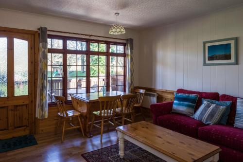 a living room with a couch and a table at River Edge Lodges in Perth