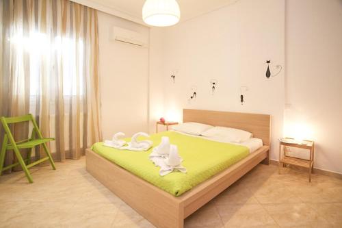 a bedroom with a bed with two swans on it at Kazarma Apartments at Klismata village in Klísmata