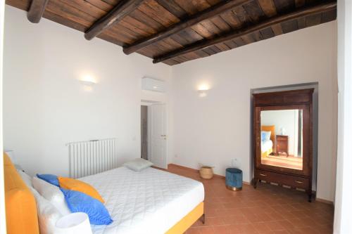 a bedroom with a white bed and a mirror at Villa Belvedere Amodeo - terrace, seaview, wifi in Conca dei Marini