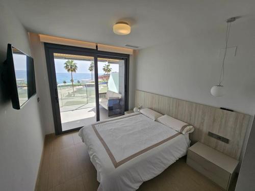 een slaapkamer met een bed en uitzicht op de oceaan bij Sidi Luxury 2 (Beach & Golf) in Alicante