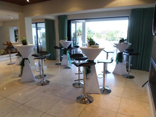 a room with stools and tables in a building at Isango Gate in Port Elizabeth