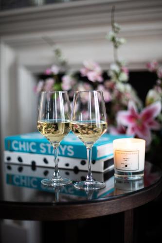 two glasses of white wine sitting on a table at One Warwick Park Hotel in Royal Tunbridge Wells