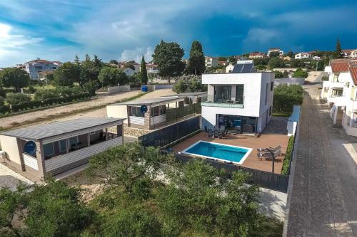 an aerial view of a house with a swimming pool at Villa Tuta with heated pool, only 150 m from the beach in Pakoštane