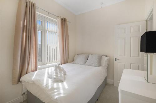 a bedroom with a white bed and a window at Falmer Serene Getaway, Newly Refurbished, Sleeps 4 in Darlington