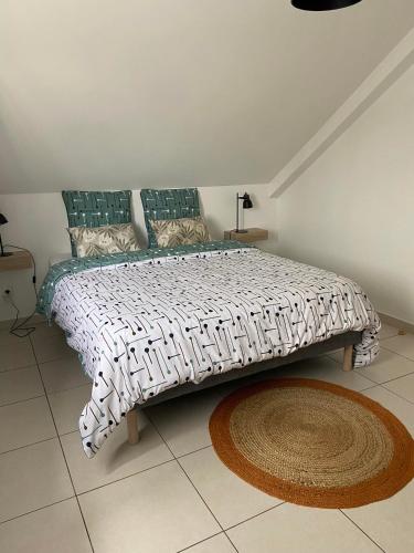 a large bed in a bedroom with a rug at L'anthurium in La Plaine des Palmistes