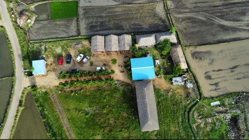 an aerial view of a house with a yard at Hippie Land Nature Stay in Hampi