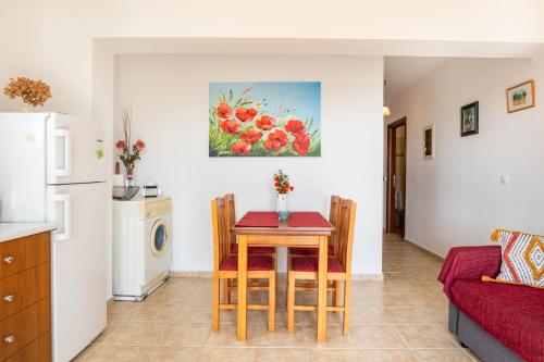 a kitchen and living room with a table and chairs at Venetia's Garden in Lefkos Karpathou