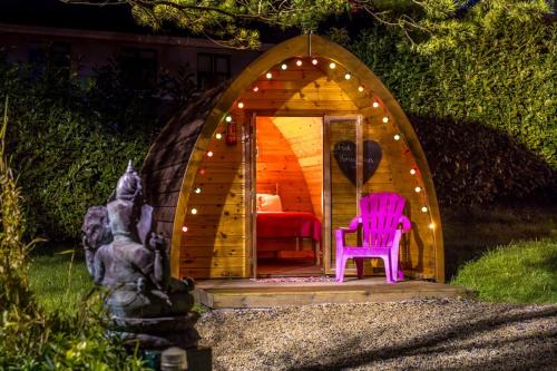 a gazebo with a pink chair in it at Podumna Glamping Village in Portumna