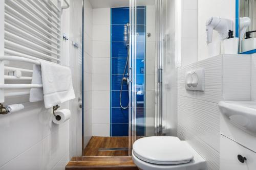 a bathroom with a toilet and a glass shower at Oliwia in Jastrzębia Góra