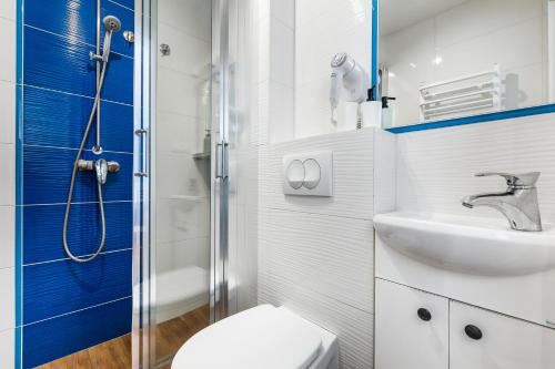 a bathroom with a shower and a toilet and a sink at Oliwia in Jastrzębia Góra