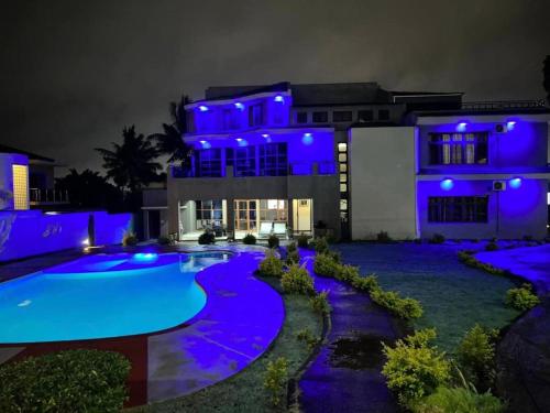 a house with a swimming pool at night at MATOLA AcCOMMODATION in Matola