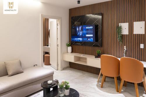 a living room with a couch and a tv at Homztality Elbatal Mohandeseen in Cairo