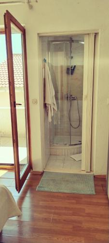 a bathroom with a shower with a glass door at Guesthouse Alliya in Dubrovnik