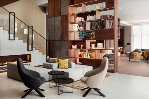 a living room with a couch and chairs and a fireplace at Courtyard by Marriott Yerevan in Yerevan