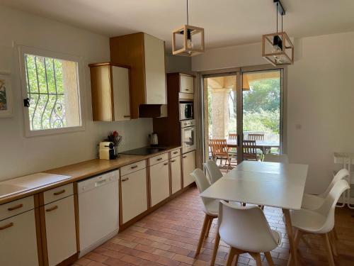 - une cuisine avec une table, une table et des chaises dans l'établissement Villa de Charme au coeur du Cap-Ferrat, à Saint-Jean-Cap-Ferrat