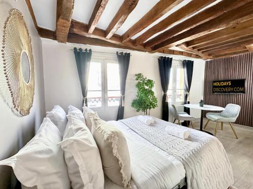 a bedroom with a large bed and a table at 841 - Panthéon chic in Paris Olympic Games 2024 in Paris