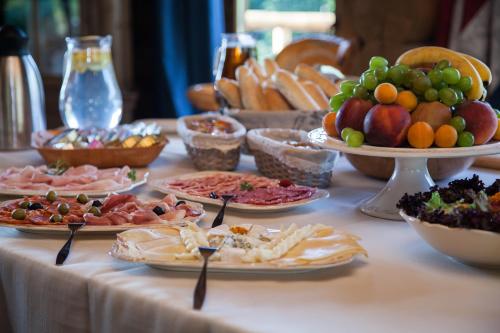 a table topped with plates of food at Wellness Cottage CEDER in Vysoké Tatry