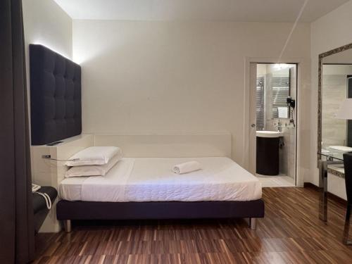 a hotel room with a bed and a bathroom at Hotel La Bussola in Milazzo
