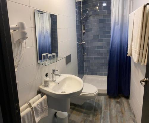 a bathroom with a sink and a toilet and a shower at Nanit Valencia Hostel in Valencia