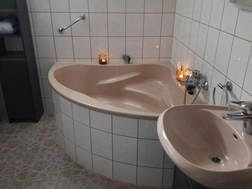 a bath tub and a sink in a bathroom at Wellness in the Naafbachtal in Much