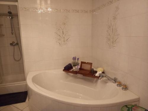 a white tub in a bathroom with a shower at Holiday apartment Bräu in Riegsee