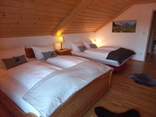 a room with two beds in a room with at Holiday apartment Bräu in Riegsee