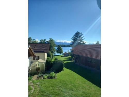 two images of a house and a yard at Holiday apartment Bräu in Riegsee