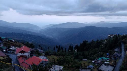 a view of a valley with mountains in the distance at Dumfu Homestay in Darjeeling
