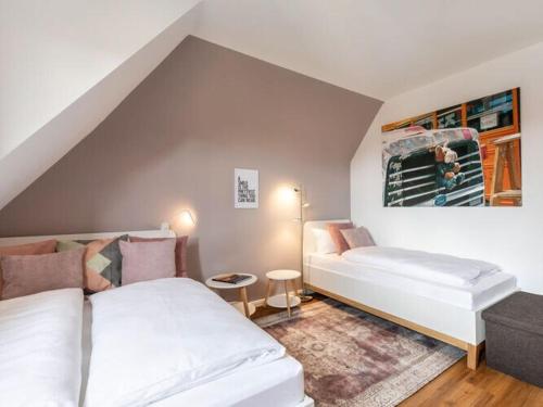 a attic room with two beds and a couch at Holiday apartment Villa PRIMERA in Singen