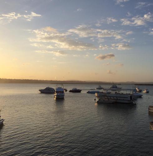 a group of boats in the water at sunset at Tudor Water Sports Hotel in Mombasa