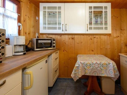 a kitchen with a counter with a table in it at Holiday home sunshine in Bad Koetzting