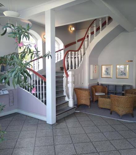 a hallway with a spiral staircase in a house at Apartment by the beach - Great facilities and consumption included in Allinge