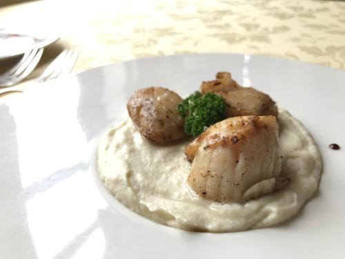 a plate of food with potatoes and broccoli on a table at Logis hôtel & Restaurant - Auberge de la Forêt in Hazebrouck