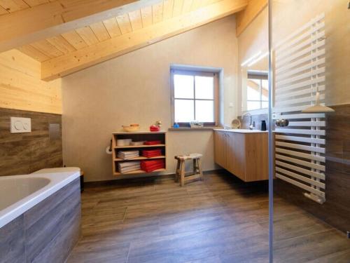 a bathroom with a shower and a tub and a sink at Holiday apartment d'griabige in Farchant