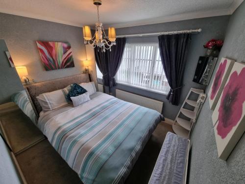 a small bedroom with a bed and a window at The Sup Shack Wellington Inn in New Quay