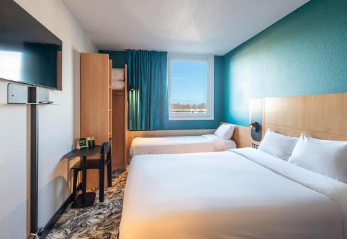 Postel nebo postele na pokoji v ubytování B&B HOTEL Calais Terminal Cité Europe 3 étoiles