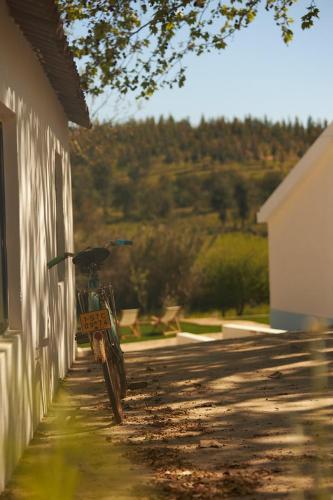 a bike parked on the side of a building at Quinta Do Marmeleiro - Casa Rosmaninho in Santiago do Cacém