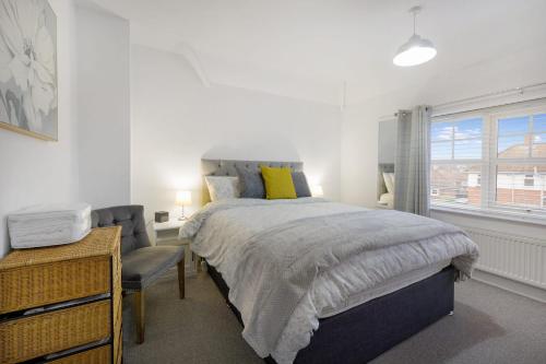 a bedroom with a bed and a chair and a window at Stylish Comfort, Near Auckland Castle, Sleeps 4 in Crook