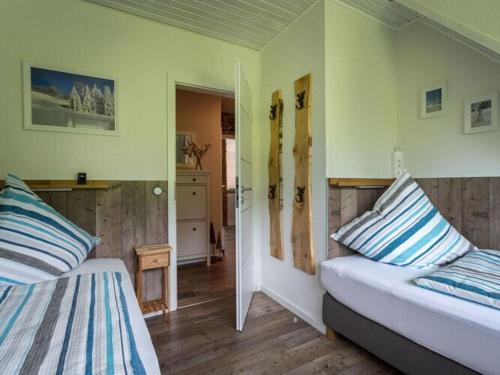 a bedroom with two beds with blue and white pillows at Holiday apartment Bergwiese in Lenzkirch