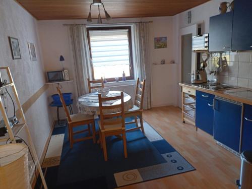a kitchen and dining room with a table and chairs at Ferienwohnung Hilla in Taben-Rodt